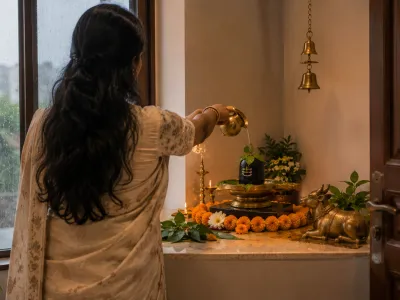 Woman performing jalabhishek at home Shiva corner during Shravan